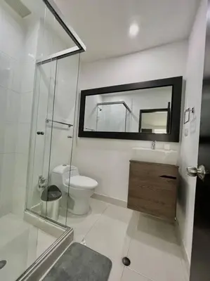 a bathroom with a toilet and a sink and a mirror at Private Jacuzzi 3 Bedroom apartment in Provenza cartagena in Medellín