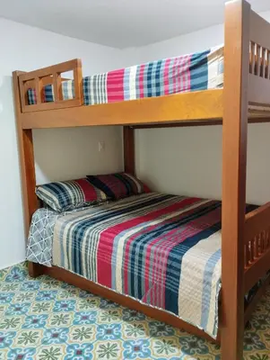 two bunk beds in a room with a bed at Jericó un pueblo de ensueño in Jericó