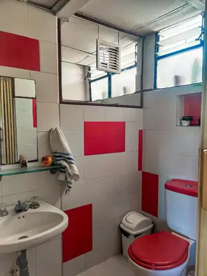 a bathroom with a sink and a toilet and a mirror at El Refugio Eco Hostal Caracolí in Cascarón