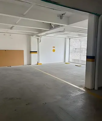 an empty parking lot in an empty parking garage at Moderno y cómodo cerca al cable in Manizales