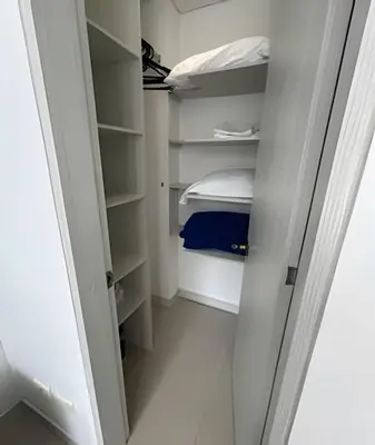 a walk in closet with white walls and shelves at Moderno y cómodo cerca al cable in Manizales