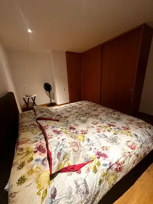 a bedroom with a bed with a floral bedspread at Apartamento Santa Coloma - WAKE FRONT in Medellín