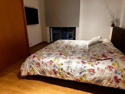 a bed with a floral comforter in a bedroom at Apartamento Santa Coloma - WAKE FRONT in Medellín