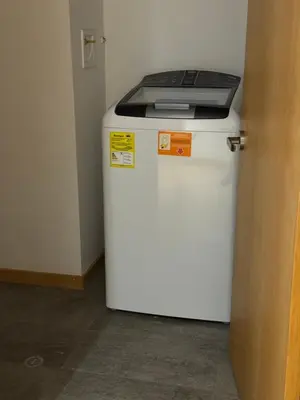 a white refrigerator with a laptop on top of it at Apartamento Santa Coloma - WAKE FRONT in Medellín