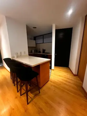 a kitchen with a table and chairs in a room at Apartamento Santa Coloma - WAKE FRONT in Medellín