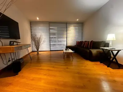 a living room with a couch and a table at Apartamento Santa Coloma - WAKE FRONT in Medellín