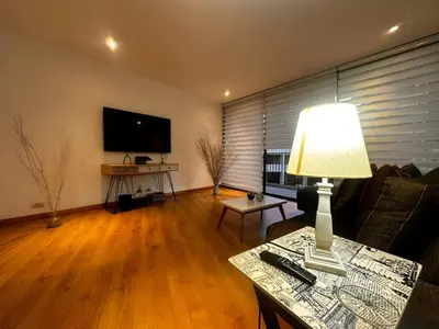 a living room with a couch and a table with a lamp at Apartamento Santa Coloma - WAKE FRONT in Medellín