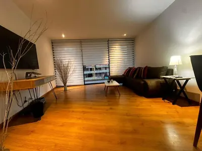 a living room with a couch and a table at Apartamento Santa Coloma - WAKE FRONT in Medellín