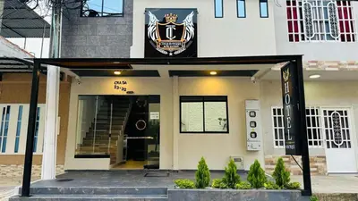 a building with a sign on the front of it at Hotel Internacional Boutique Milan in Puerto Boyacá