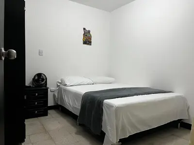 a bedroom with a bed with a cat on the wall at Hogar El Descanso Itagui in Itagüí