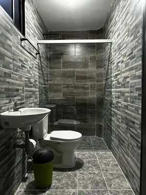 a bathroom with a toilet and a sink at Hogar El Descanso Itagui in Itagüí