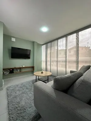a living room with a gray couch and a table at Modernos apartamentos cerca al Poblado in Medellín