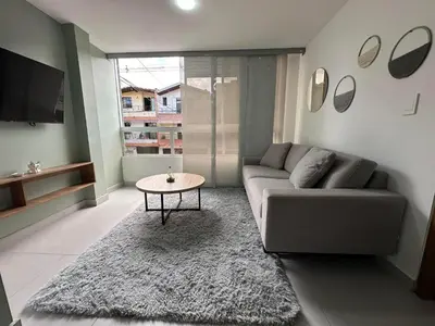 a living room with a couch and a table at Modernos apartamentos cerca al Poblado in Medellín