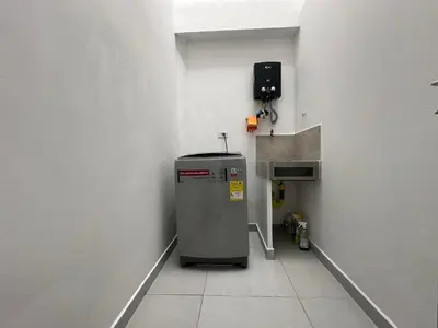 a small refrigerator in a room with a wall at Modernos apartamentos cerca al Poblado in Medellín