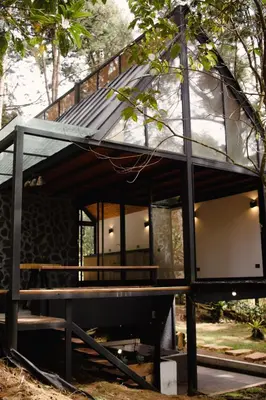 a glass house on a bench in the woods at Cabaña Onix - La Pascana Ecolodge in Mazo
