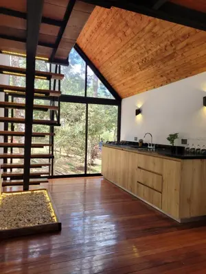 a kitchen with wooden floors and a large window at Cabaña Onix - La Pascana Ecolodge in Mazo