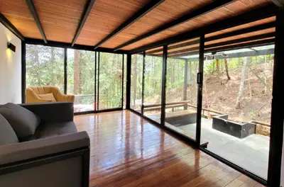 a living room with glass doors and a couch at Cabaña Onix - La Pascana Ecolodge in Mazo