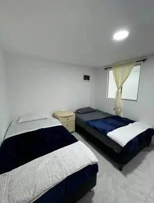 a bedroom with two beds and a window at Alojamiento en Sonsón in Sonsón