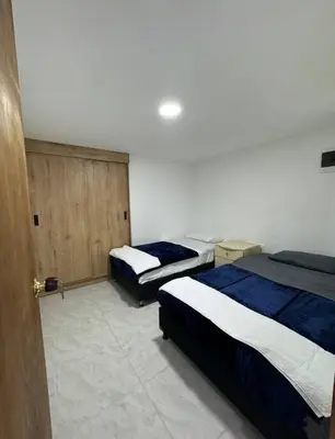 a room with two beds and a door with a room with two beds at Alojamiento en Sonsón in Sonsón
