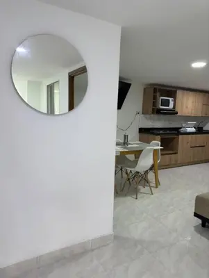 a living room with a table and a mirror at Alojamiento en Sonsón in Sonsón