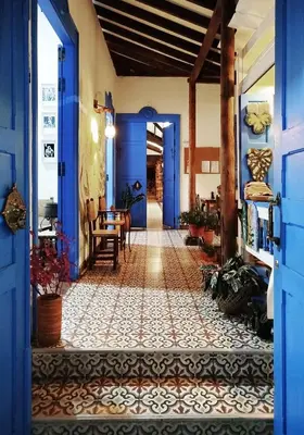 a hallway with blue doors and a tile floor at Patio Chic in Jericó