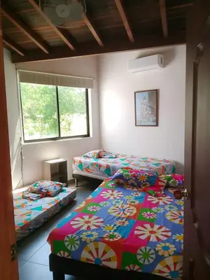 a room with two beds and a window at Casa Lili in Sopetran