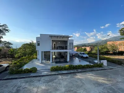 a white house with a car parked in a parking lot at Casa Lili in Sopetran