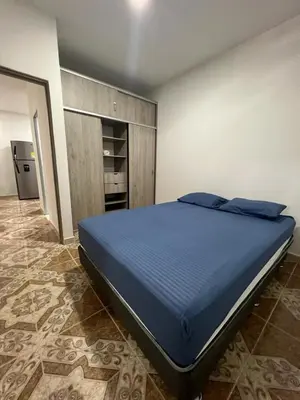 a bedroom with a large blue bed in a room at Agua Clara Apartamento in San Rafael