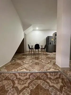 a room with a table and chairs on a tile floor at Agua Clara Apartamento in San Rafael