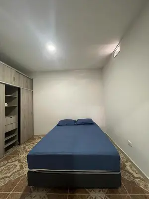 a bedroom with a large blue bed in a room at Agua Clara Apartamento in San Rafael
