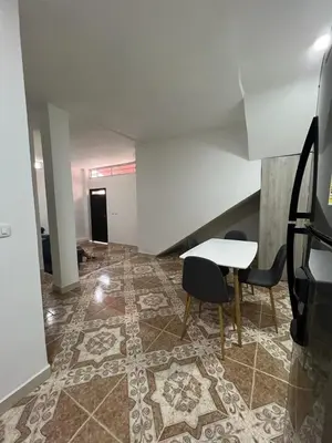 an empty room with a table and chairs on a tile floor at Agua Clara Apartamento in San Rafael