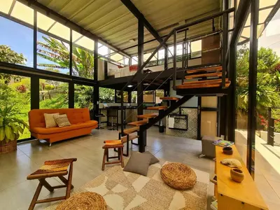 a living room with a staircase in a house at Los Bambúes in El Peñol