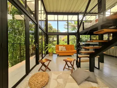 a living room with a staircase in a house at Los Bambúes in El Peñol