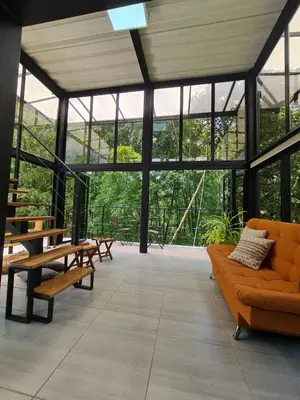 a large open room with benches and windows at Los Bambúes in El Peñol