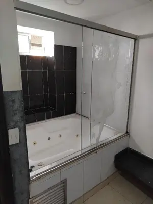 a glass shower in a bathroom with a tub at Hotel Medellin Park in Medellín