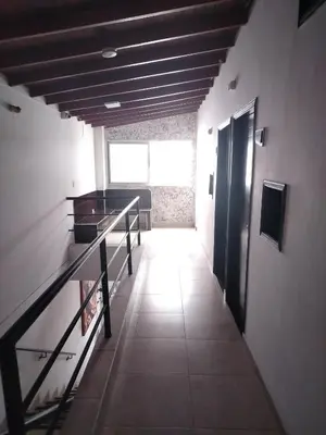 a hallway of a building with a staircase and a window at Hotel Medellin Park in Medellín