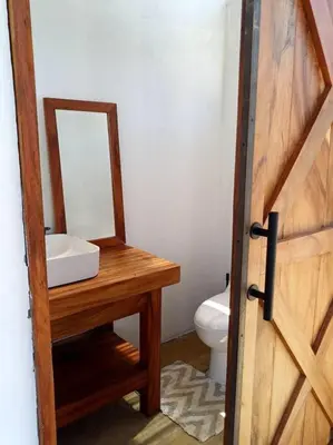 a bathroom with a sink and a mirror next to a toilet at Vista preciosa-clima cálido-calma-pueblo histórico in Santa Fe de Antioquia