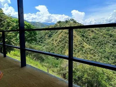 a view of a mountain from a window at Vista preciosa-clima cálido-calma-pueblo histórico in Santa Fe de Antioquia