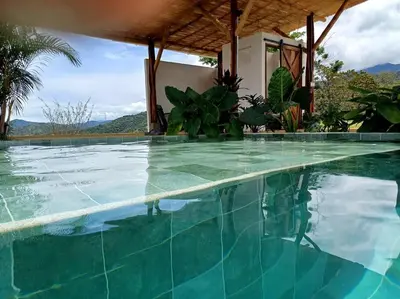 a swimming pool with blue water in a resort at Vista preciosa-clima cálido-calma-pueblo histórico in Santa Fe de Antioquia