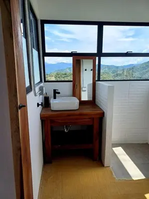 a bathroom with a sink and a large window at Vista preciosa-clima cálido-calma-pueblo histórico in Santa Fe de Antioquia