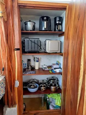 a kitchen pantry with pots and pans on shelves at Vista preciosa-clima cálido-calma-pueblo histórico in Santa Fe de Antioquia
