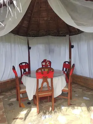 a dining table and chairs in a tent at Cabaña Campestre San Gabriel in Angostura
