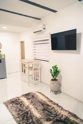 a living room with a tv and a potted plant at Apto 203 - Casa bendita in Medellín