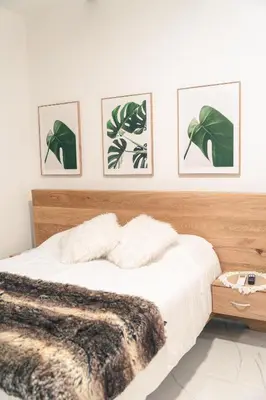 a bedroom with a bed and four pictures on the wall at Apto 203 - Casa bendita in Medellín