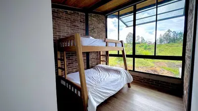 a bunk bed in a room with a window at Babakan in San Rafael