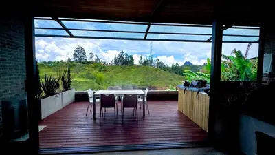 a patio with a table and chairs on a deck at Babakan in San Rafael