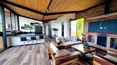 a living room with a couch and a fireplace at Babakan in San Rafael