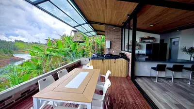 a balcony with a table and chairs and a kitchen at Babakan in San Rafael