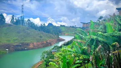 a river in the middle of a valley with green hills at Babakan in San Rafael