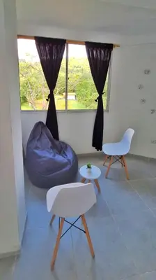 a living room with a blue bean bag chair and tables at OSIMiRI JAMAICA II-Piscina, naturaleza mágica in San Rafael